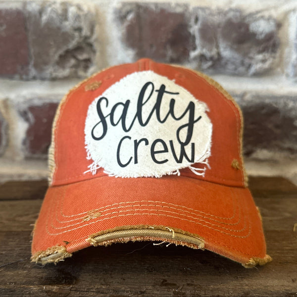 Salty Crew hat by BohoGroove with black Salty Crew lettering on a distressed off-white patch on an orange vintage distressed snapback.