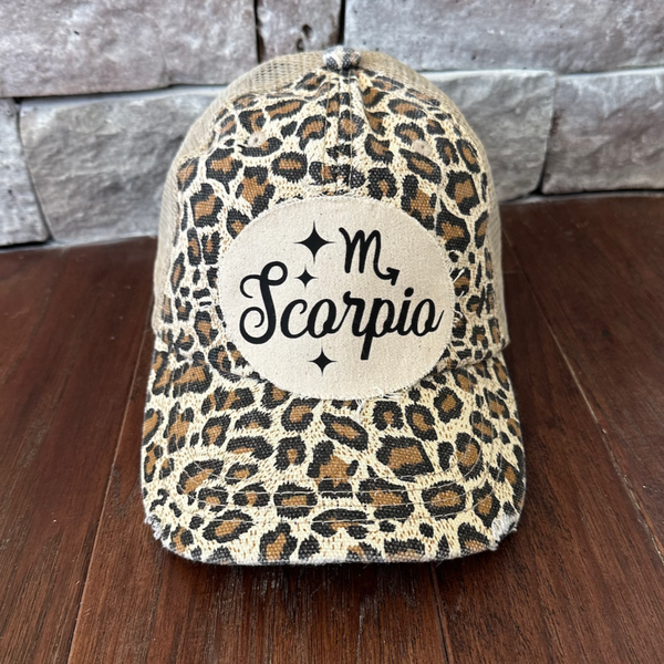Scorpio hat by BohoGroove with black Scorpio lettering and constellation graphic on a distressed off-white custom patch on a leopard vintage distressed snapback.