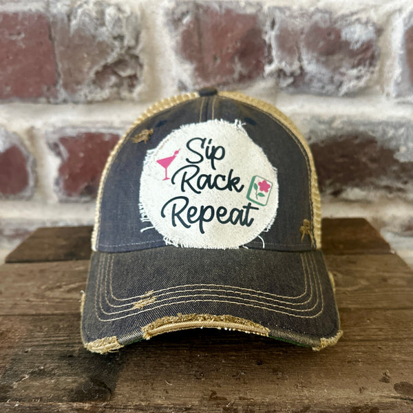 Sip, Rack, Repeat Mahjong hat by BohoGroove featuring black Sip, Rack, Repeat lettering with Mahjong tile graphic and a pink martini glass on an off-white distressed patch on a navy vintage distressed snapback trucker hat.