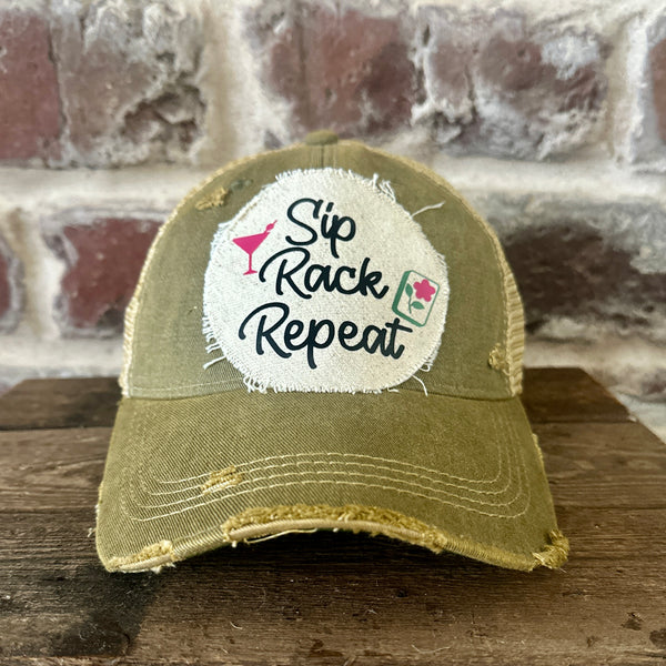 Sip, Rack, Repeat Mahjong hat by BohoGroove featuring black Sip, Rack, Repeat lettering with Mahjong tile graphic and a pink martini glass on an off-white distressed patch on an olive vintage distressed snapback trucker hat.