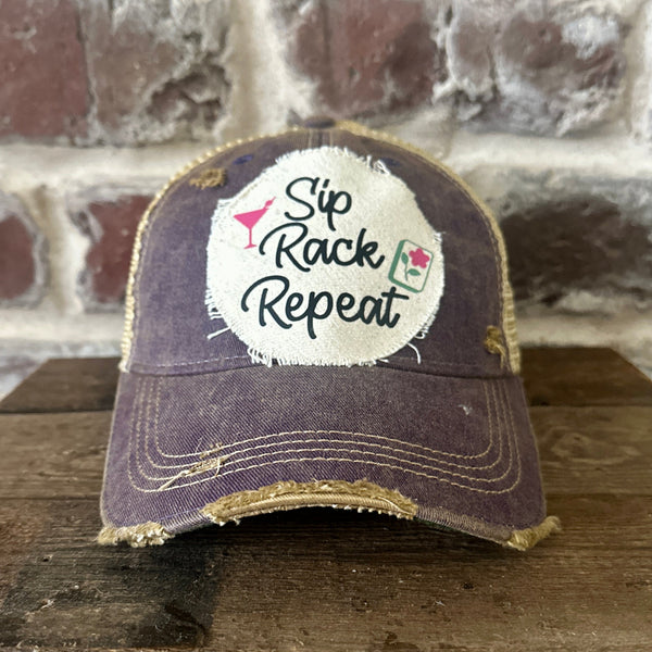 Sip, Rack, Repeat Mahjong hat by BohoGroove featuring black Sip, Rack, Repeat lettering with Mahjong tile graphic and a pink martini glass on an off-white distressed patch on a purple vintage distressed snapback trucker hat.