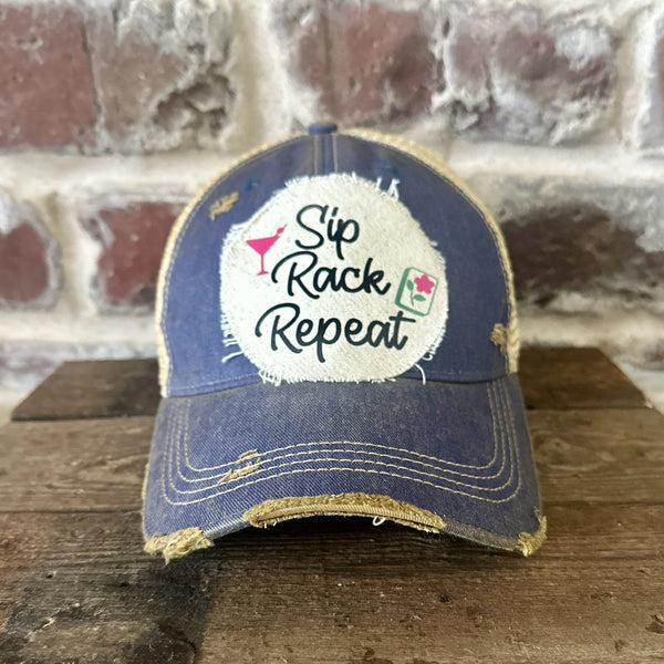 Sip, Rack, Repeat Mahjong hat by BohoGroove featuring black Sip, Rack, Repeat lettering with Mahjong tile graphic and a pink martini glass on an off-white distressed patch on a royal vintage distressed snapback trucker hat.