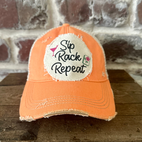 Sip, Rack, Repeat Mahjong hat by BohoGroove featuring black Sip, Rack, Repeat lettering with Mahjong tile graphic and a pink martini glass on an off-white distressed patch on a sherbet vintage distressed snapback trucker hat.
