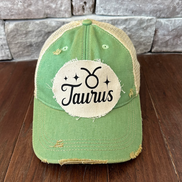 Taurus hat by BohoGroove with black Taurus lettering and constellation graphic on a distressed off-white custom patch on a mint vintage distressed snapback.
