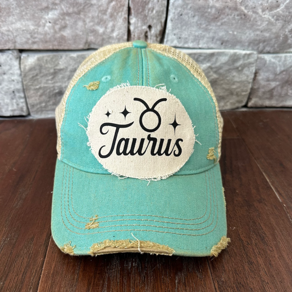Taurus hat by BohoGroove with black Taurus lettering and constellation graphic on a distressed off-white custom patch on an ocean blue vintage distressed snapback.