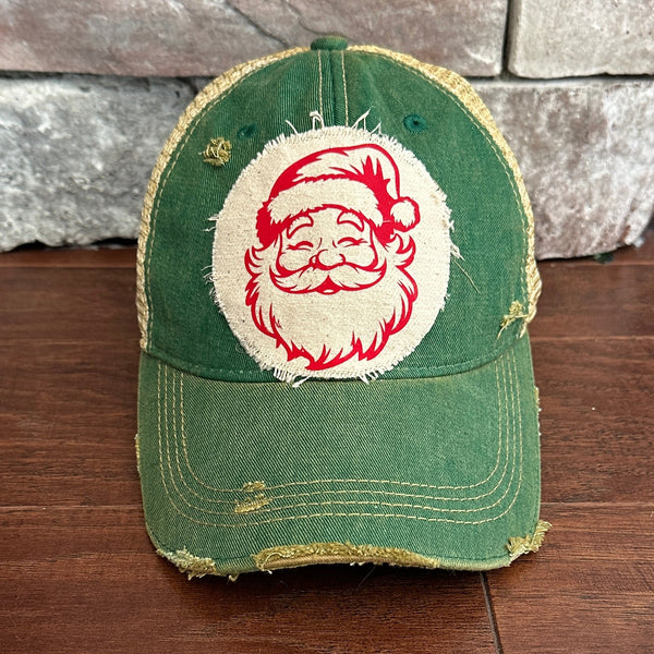 Vintage Santa hat by BohoGroove with a red Santa Claus face graphic on a distressed off-white custom patch on a green vintage distressed snapback.