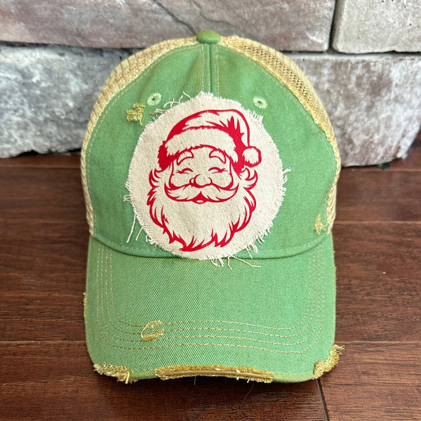 Vintage Santa hat by BohoGroove with a red Santa Claus face graphic on a distressed off-white custom patch on a mint vintage distressed snapback.