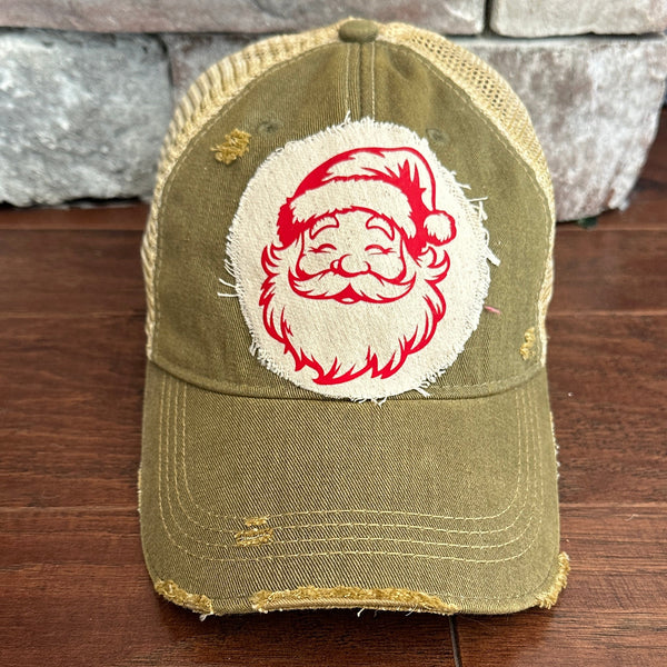 Vintage Santa hat by BohoGroove with a red Santa Claus face graphic on a distressed off-white custom patch on an olive vintage distressed snapback.