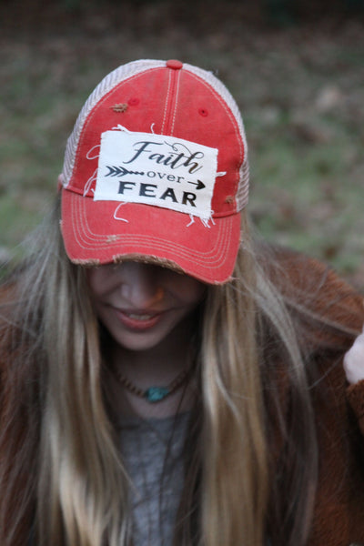 Model wearing red BohoGroove Faith Over Fear Hat
