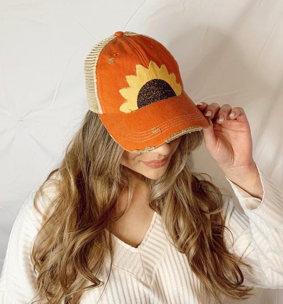 lady wearing bohogroove orange sunflower hat looking right
