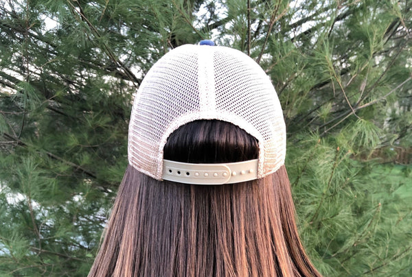Back view of BohoGroove vintage distressed trucker hat with adjustable snapback closure and mesh back on model-2.
