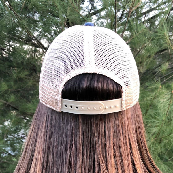 Back view of BohoGroove vintage distressed trucker hat with adjustable snapback closure and mesh back on model 1.