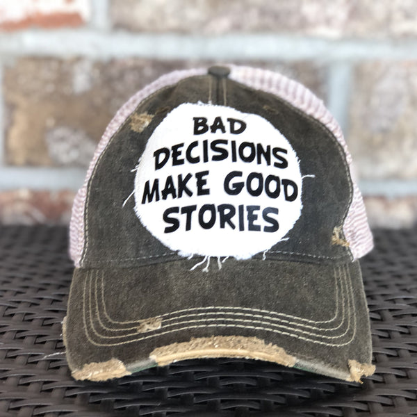 Bad Decisions Make Good Stories hat by BohoGroove with black Bad Decisions Make Good Stories lettering on a distressed off-white patch on a black vintage distressed snapback trucker hat.