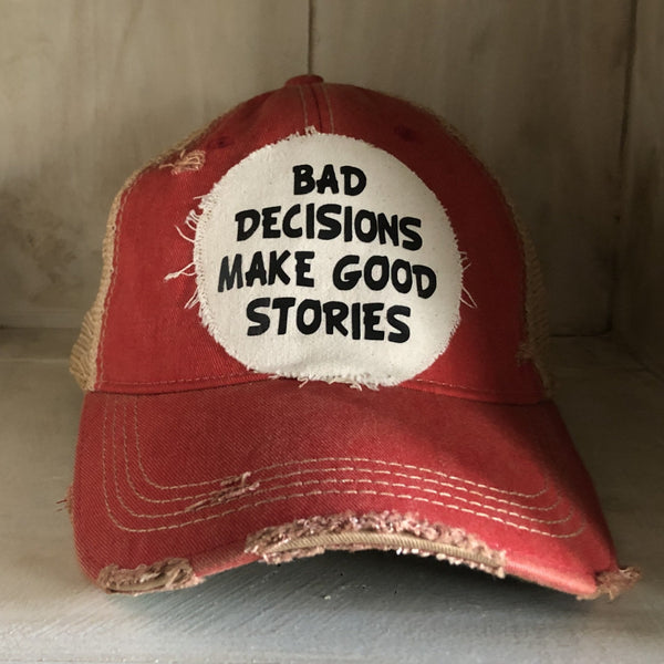 Bad Decisions Make Good Stories hat by BohoGroove with black Bad Decisions Make Good Stories lettering on a distressed off-white patch on a red vintage distressed snapback trucker hat.