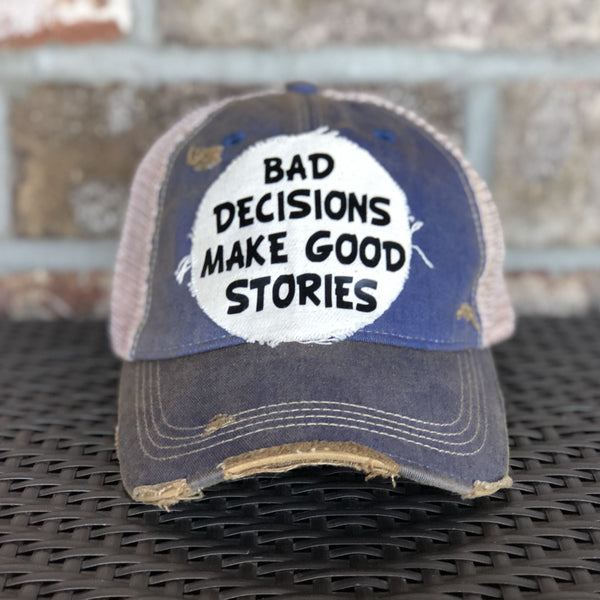 Bad Decisions Make Good Stories hat by BohoGroove with black Bad Decisions Make Good Stories lettering on a distressed off-white patch on a royal blue vintage distressed snapback trucker hat.