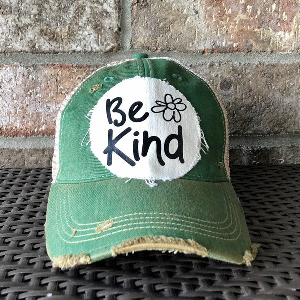 Be Kind hat by BohoGroove with black Be Kind lettering and flower graphic on distressed off-white patch on green vintage distressed snapback.