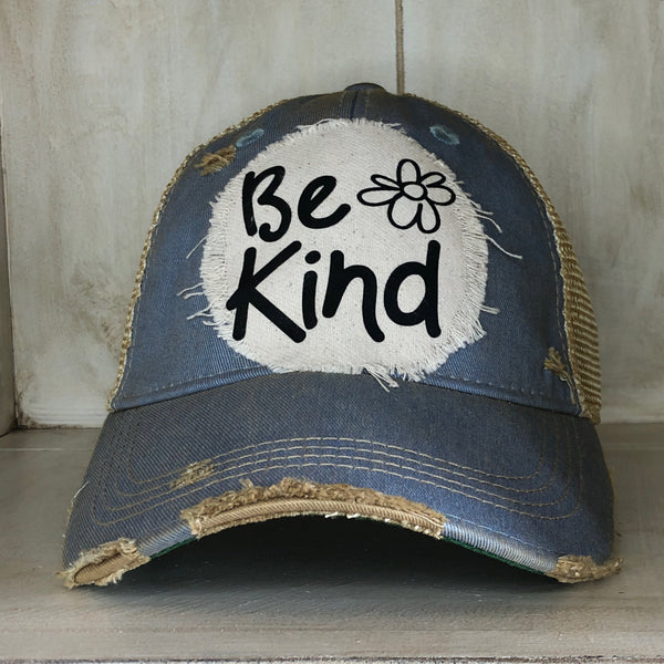 Be Kind hat by BohoGroove with black Be Kind lettering and flower graphic on distressed off-white patch on light blue vintage distressed snapback.