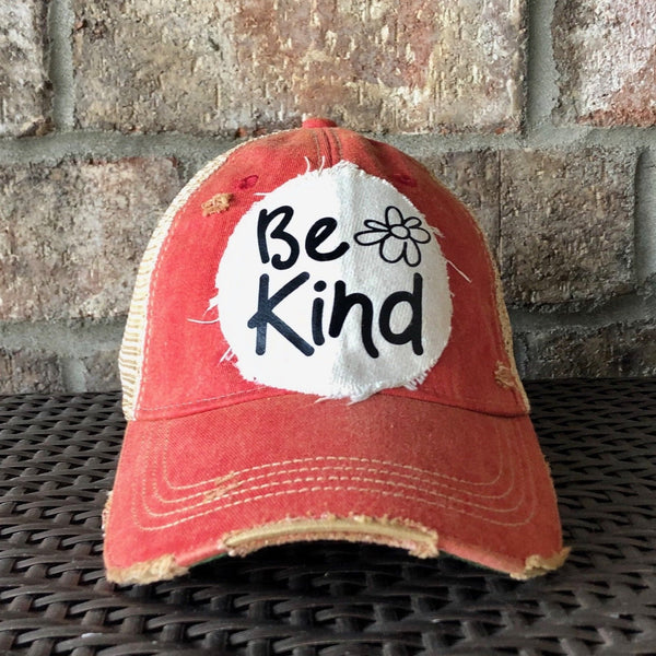 Be Kind hat by BohoGroove with black Be Kind lettering and flower graphic on distressed off-white patch on red vintage distressed snapback.