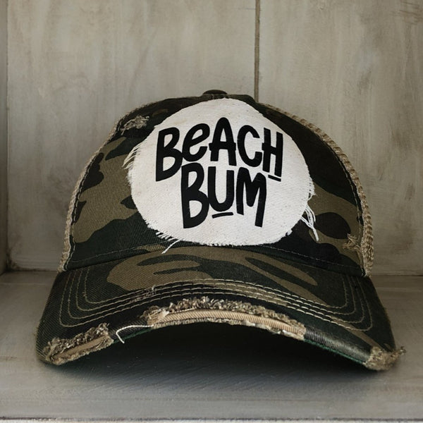 Beach Bum hat by BohoGroove featuring distressed off-white patch with black Beach Bum lettering on a camo vintage distressed snapback