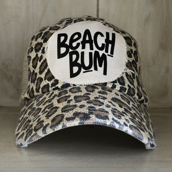 Beach Bum hat by BohoGroove featuring distressed off-white patch with black Beach Bum lettering on a leopard vintage distressed snapback