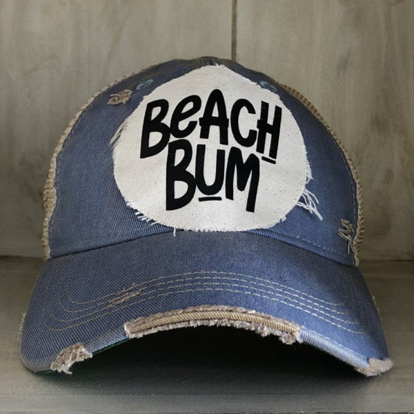 Beach Bum hat by BohoGroove with black Beach Bum lettering on distressed off-white patch on a light blue vintage distressed snapback.