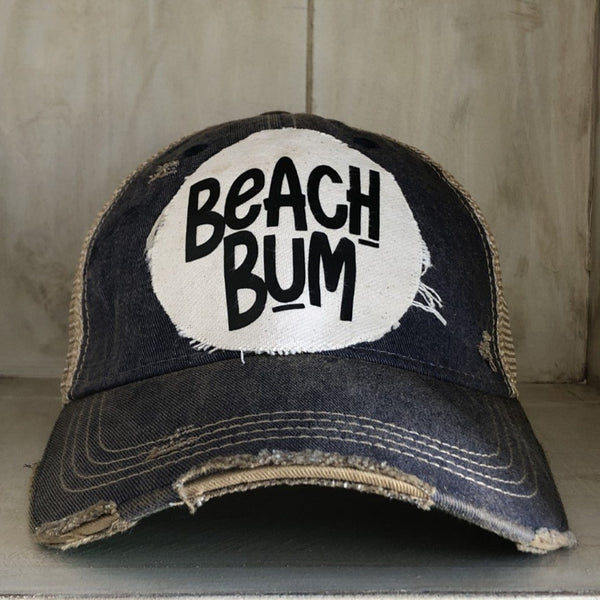 Beach Bum hat by BohoGroove with black Beach Bum lettering on distressed off-white patch on a navy blue vintage distressed snapback.