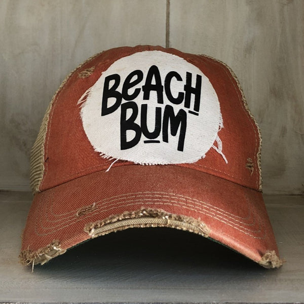 Beach Bum hat by BohoGroove with black Beach Bum lettering on distressed off-white patch on a orange vintage distressed snapback.
