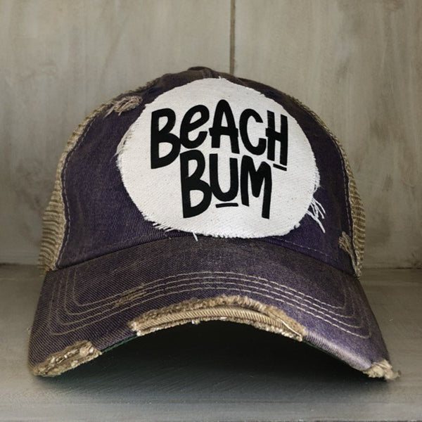 Beach Bum hat by BohoGroove with black Beach Bum lettering on distressed off-white patch on a purple vintage distressed snapback.