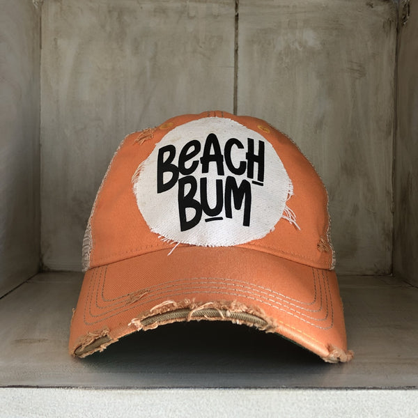 Beach Bum hat by BohoGroove with black Beach Bum lettering on distressed off-white patch on a sherbet vintage distressed snapback.