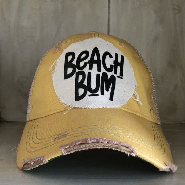 Beach Bum hat by BohoGroove with black Beach Bum lettering on distressed off-white patch on a yellow vintage distressed snapback.