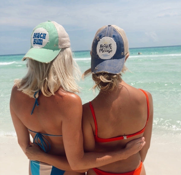 Models wearing BohoGroove Beach Please and Beach Bum vintage distressed snapback hats at the beach.