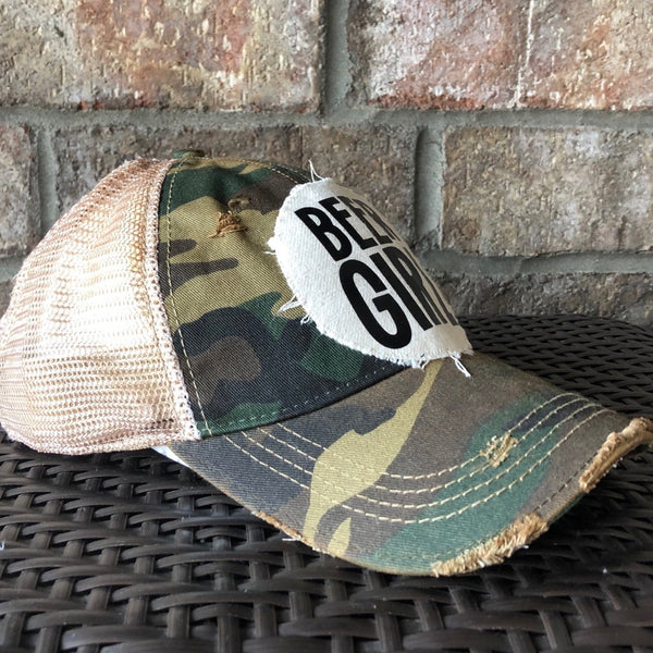 Left side view of a Beer Girl hat by BohoGroove with black Beer Girl lettering on a distressed off-white patch on a camo vintage distressed snapback trucker hat.