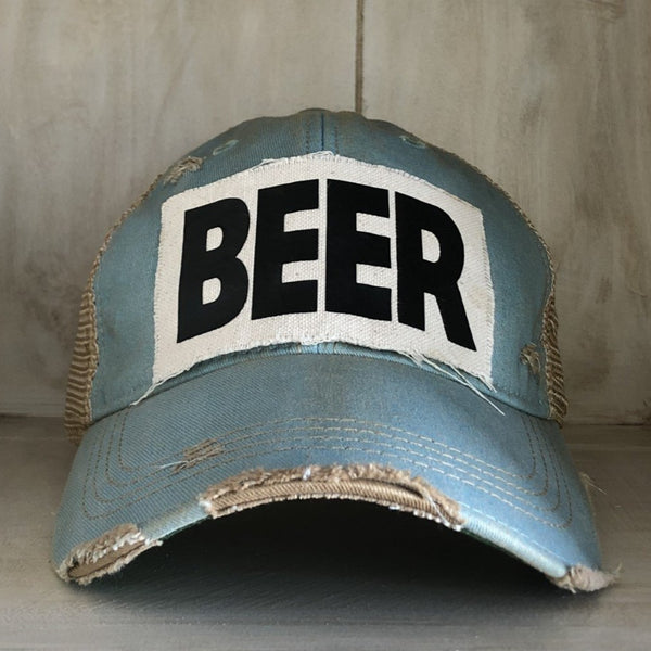 Beer hat by BohoGroove with black lettering on a distressed off-white custom patch on an ocean blue vintage distressed snapback.