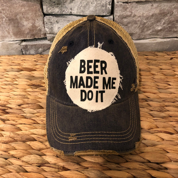 Beer Made Me Do It hat by BohoGroove featuring black Beer Made Me Do It lettering on a distressed off-white patch on a navy blue vintage distressed snapback trucker hat.