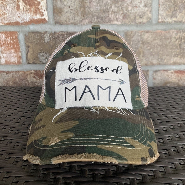 Blessed Mama hat by BohoGroove featuring black Blessed Mama lettering and arrow graphic on a camo vintage distressed snapback hat