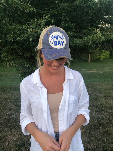 Girl wearing a blue BohoGroove game day hat