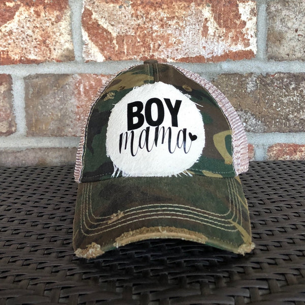 Boy Mama Hat by BohoGroove with black Boy Mama lettering and heart graphic on distressed off-white patch on a camo vintage distressed snapback