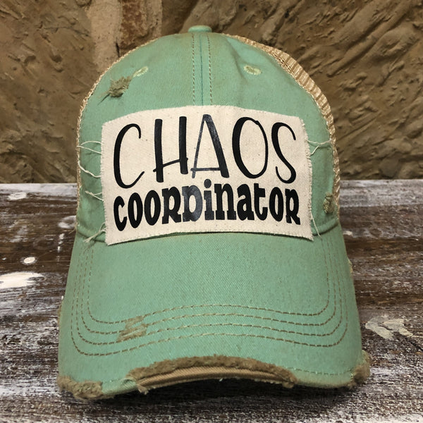 Chaos Coordinator hat by BohoGroove with black Chaos Coordinator lettering on a distressed off-white patch on a mint vintage distressed snapback trucker hat.