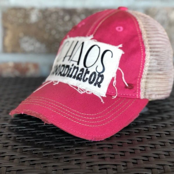 Right  side view of Chaos Coordinator hat by BohoGroove with black Chaos Coordinator lettering on a distressed off-white patch on a pink vintage distressed snapback trucker hat.