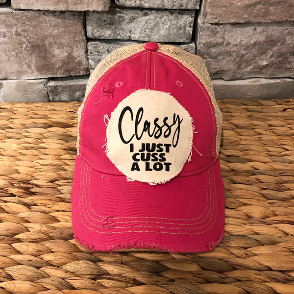 Classy, I Just Cuss a Lot hat by BohoGroove with black lettering on a distressed off-white patch on a pink vintage distressed snapback trucker hat.