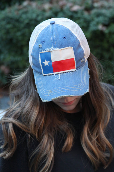 Woman wearing Texas Flag hat by BohoGroove featuring Texas flag patch on royal blue vintage distressed snapback