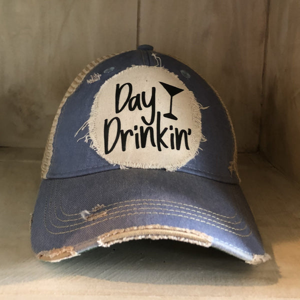 Day Drinkin hat by BohoGroove with black Day Drinkin lettering and martini glass graphic on distressed off-white patch on a light blue vintage distressed snapback.