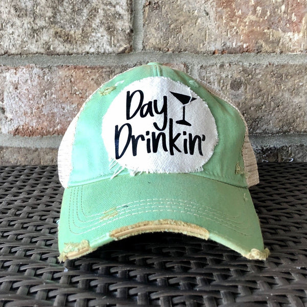 Day Drinkin hat by BohoGroove with black Day Drinkin lettering and martini glass graphic on distressed off-white patch on a mint green vintage distressed snapback.