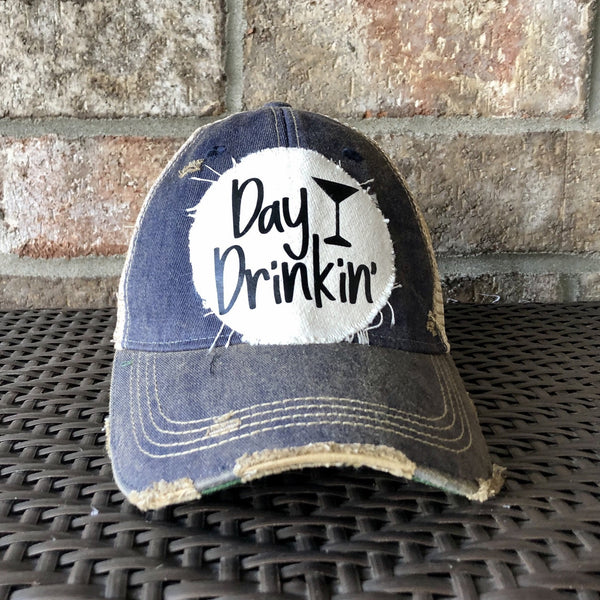 Day Drinkin hat by BohoGroove with black Day Drinkin lettering and martini glass graphic on distressed off-white patch on a navy blue vintage distressed snapback.