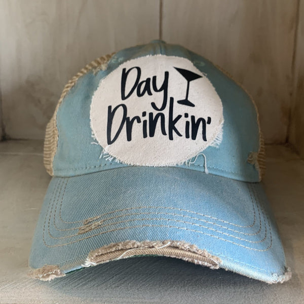 Day Drinkin hat by BohoGroove with black Day Drinkin lettering and martini glass graphic on distressed off-white patch on an ocean blue vintage distressed snapback.