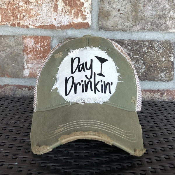 Day Drinkin hat by BohoGroove with black Day Drinkin lettering and martini glass graphic on distressed off-white patch on an olive vintage distressed snapback.