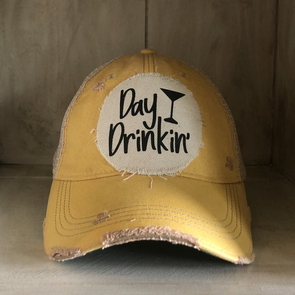 Day Drinkin hat by BohoGroove with black Day Drinkin lettering and martini glass graphic on distressed off-white patch on a yellow vintage distressed snapback.