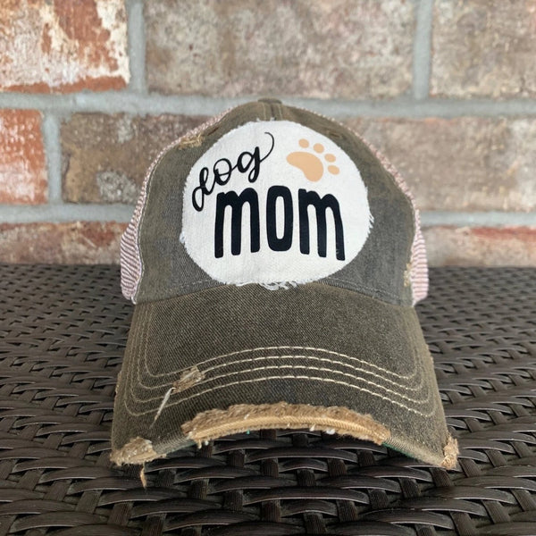 Dog Mom hat by BohoGroove featuring black Dog Mom lettering and tan paw print graphic on a black vintage distressed snapback hat