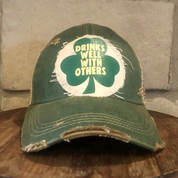 Drinks Well With Others hat by BohoGroove with black lettering on a distressed off-white custom patch on a green vintage distressed snapback.