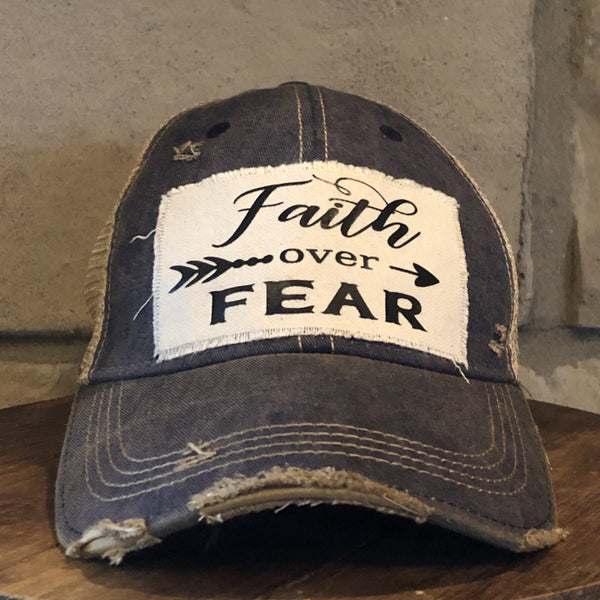 Faith Over Fear hat by BohoGroove with black Faith Over Fear lettering and arrow graphic on distressed off-white patch on navy vintage distressed snapback.